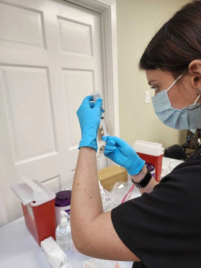 student drawing liquid from vial